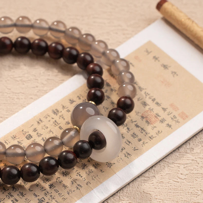 A unique Chinese-style double-wrap bracelet featuring small-leaf rosewood and gray agate round beads, inspired by Fuyao Wutai.