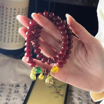 Natural Red Bodhi Root Abacus Bead Bracelet with a Family of Three Golden Pixiu Design, Double-Layer Strand.