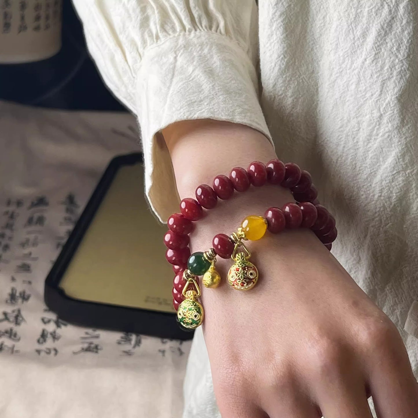 Natural Red Bodhi Root Abacus Bead Bracelet with a Family of Three Golden Pixiu Design, Double-Layer Strand.